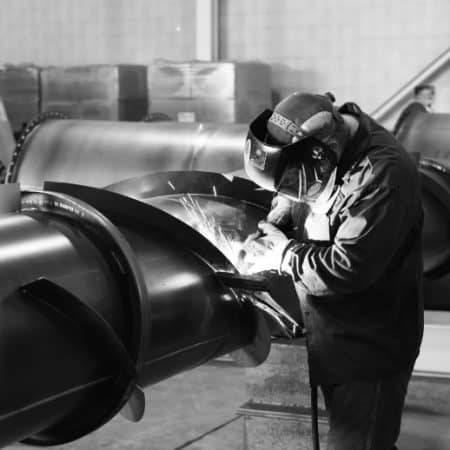 Fabricator welding a stack