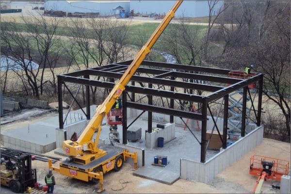 Structural steel at baghouse installation site for foundry with crane
