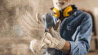 Industrial worker surrounded by airborne dust particles